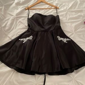 Black strapless dress with sequin embellished pockets